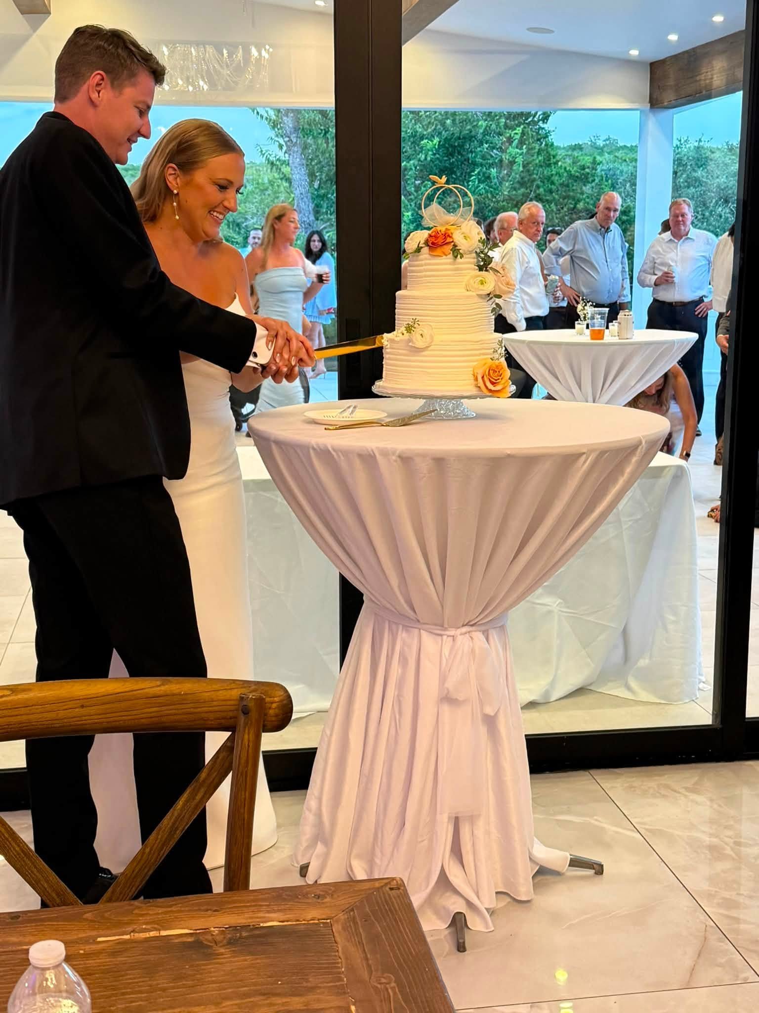 Newlyweds cutting their wedding cake